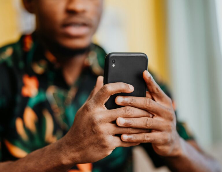 A man holding a phone while scanning a QR code